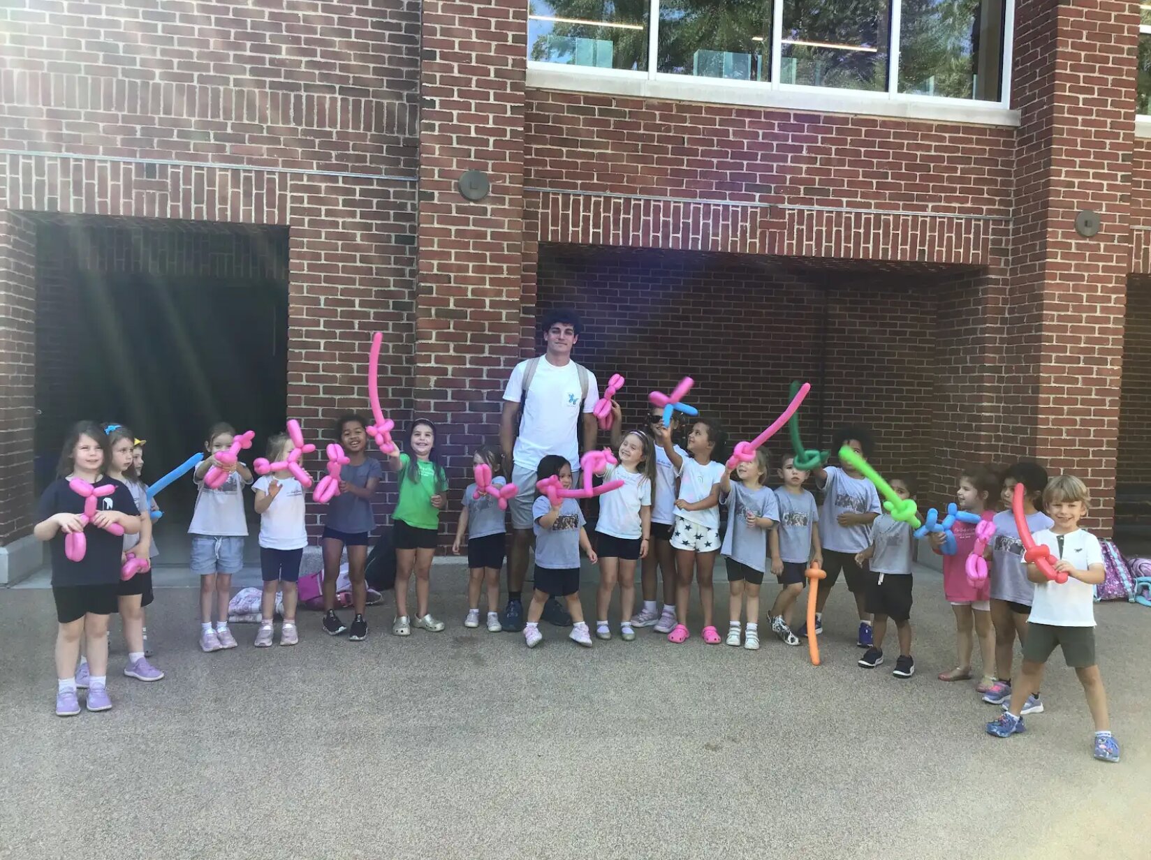 Children showing off colorful balloon animals